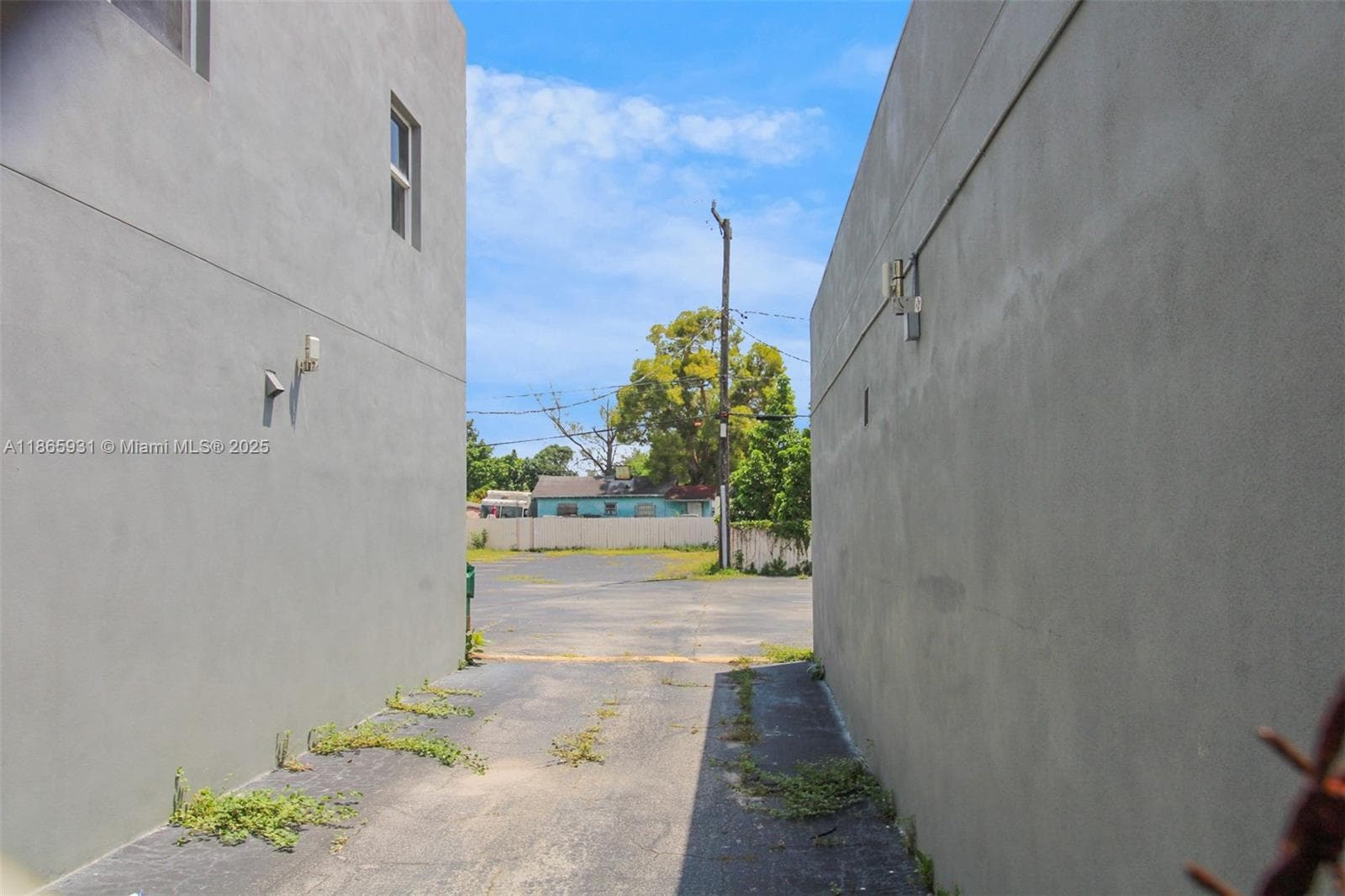 Central drive between two buildings allow access to paved parking in rear.