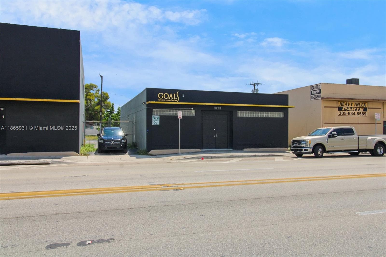 Central drive between two buildings allow access to paved parking in rear.
