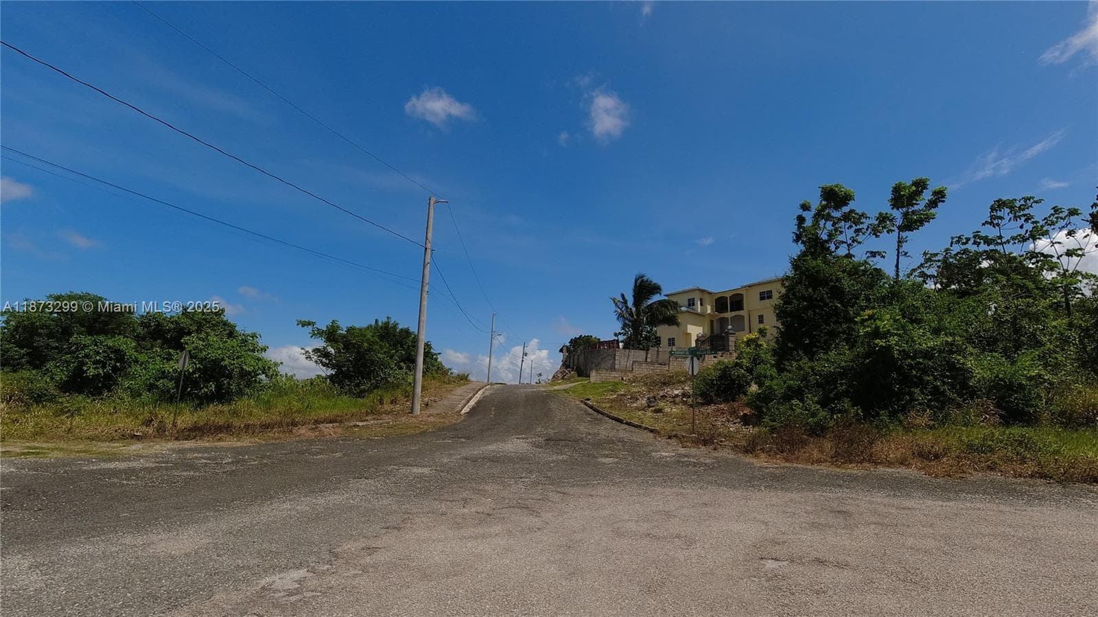 View of Corner lot 443 on left at crossroads. Existing dwelling across from lot.