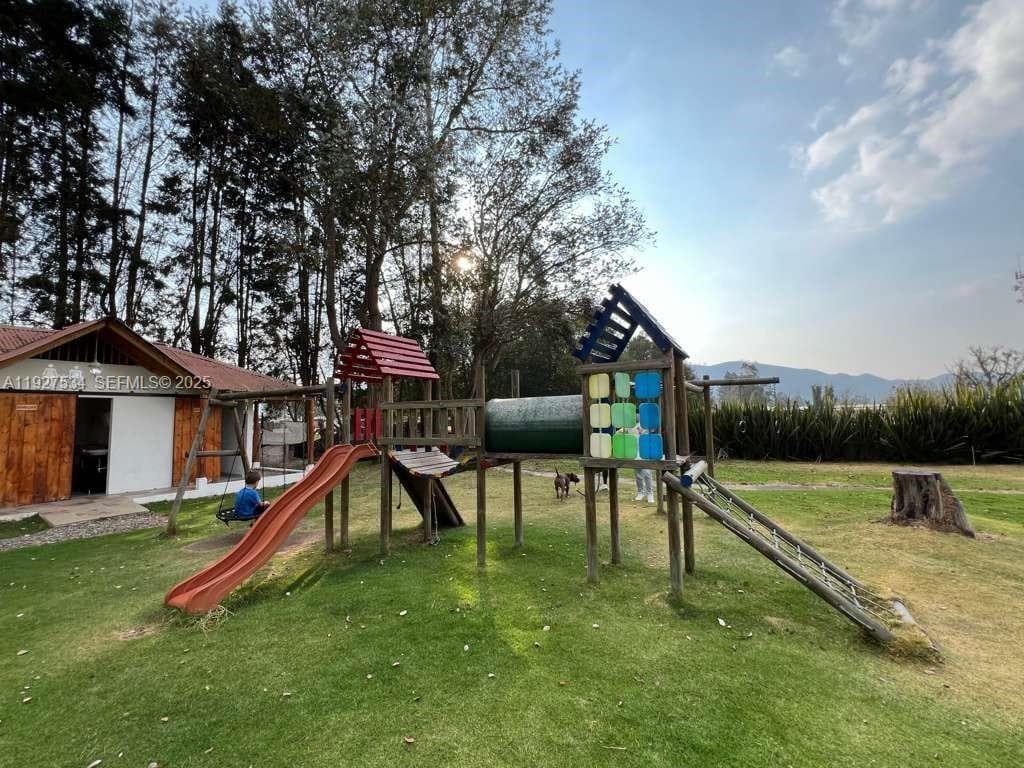Outdoor children’s play area with supporting facilities nearby, offering ample space and a safe, open-air environment.
