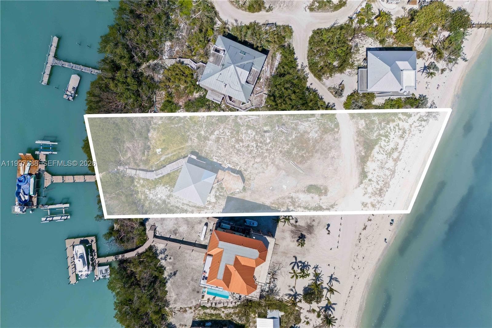 Small guest home remains and is sold as-is. This is a rare property offering Bay to Gulf access with deep waters and multiple boat lifts!