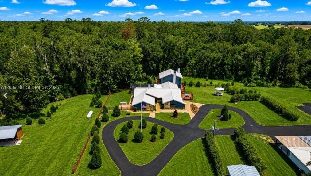 Aerial perspective showcasing the extraordinary scale of the estate's commercial and storage facilities, including multiple high-capacity structures designed for vehicle collections, equipment storage, business operations, and future expansion.