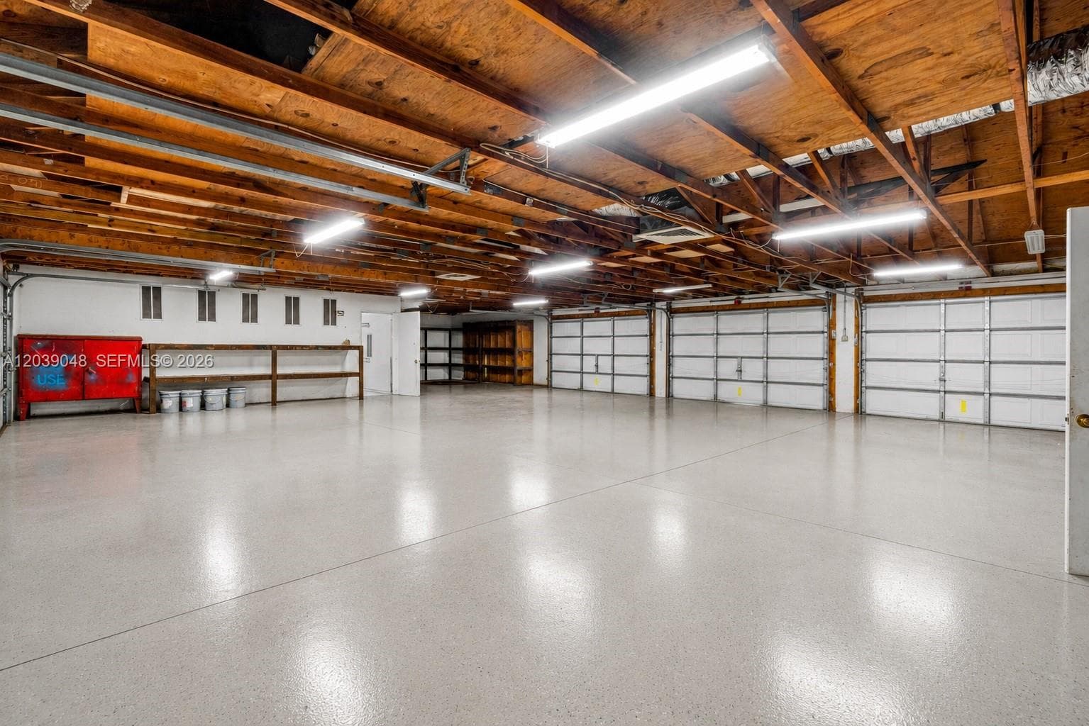Expansive garage infrastructure featuring two separate buildings with combined 8-car capacity, ideal for collectors or those seeking elevated storage and utility options.