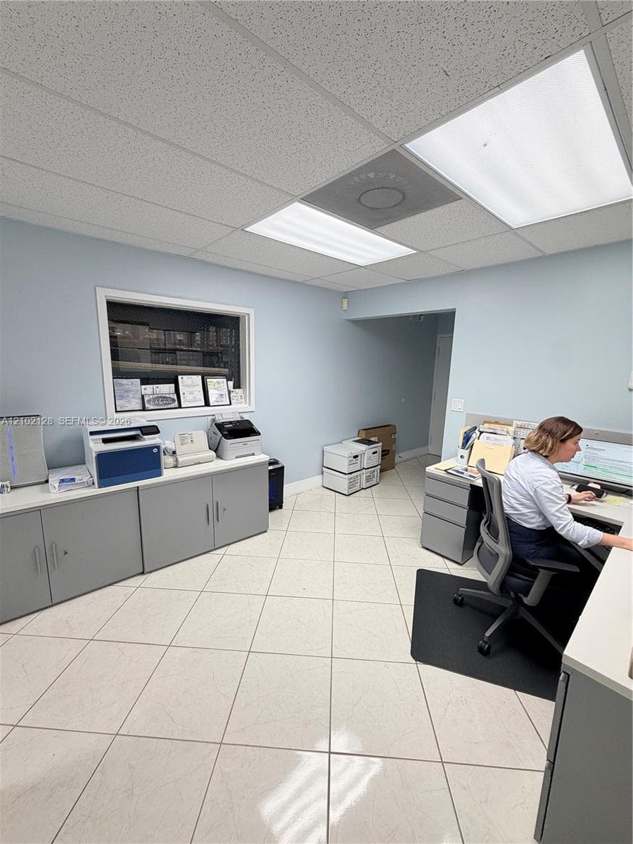 Recessed lighting, drop ceiling, tile flooring, built-in cabinetry, interior window