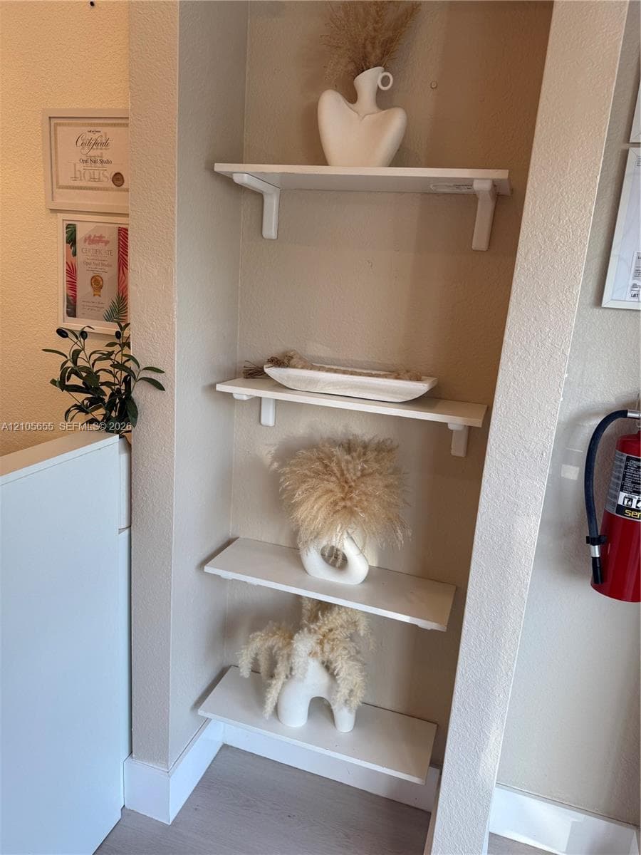 Recessed wall niche featuring four built-in white shelving tiers
