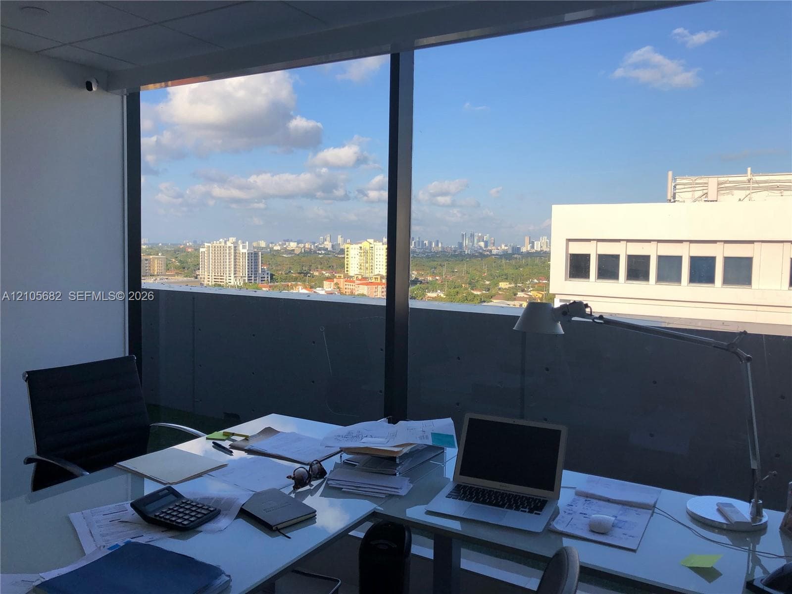 Floor-to-ceiling windows featuring expansive urban horizons and aluminum framing