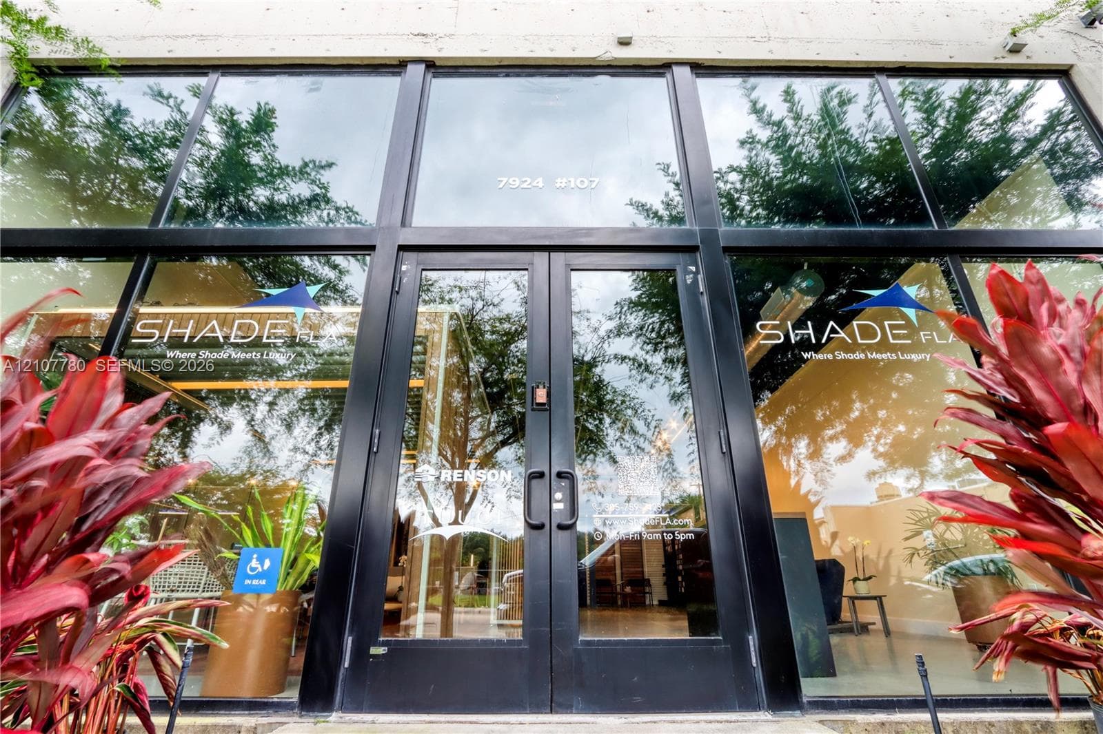 Floor-to-ceiling glass storefront facade with black metal framing and double-door entry