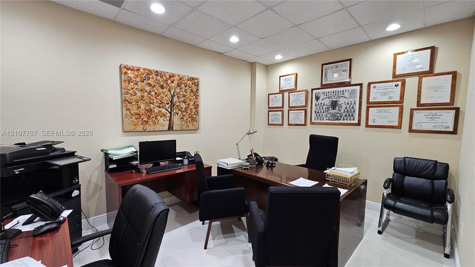 Interior room featuring a drop ceiling with recessed lighting and neutral-tone wall finishes