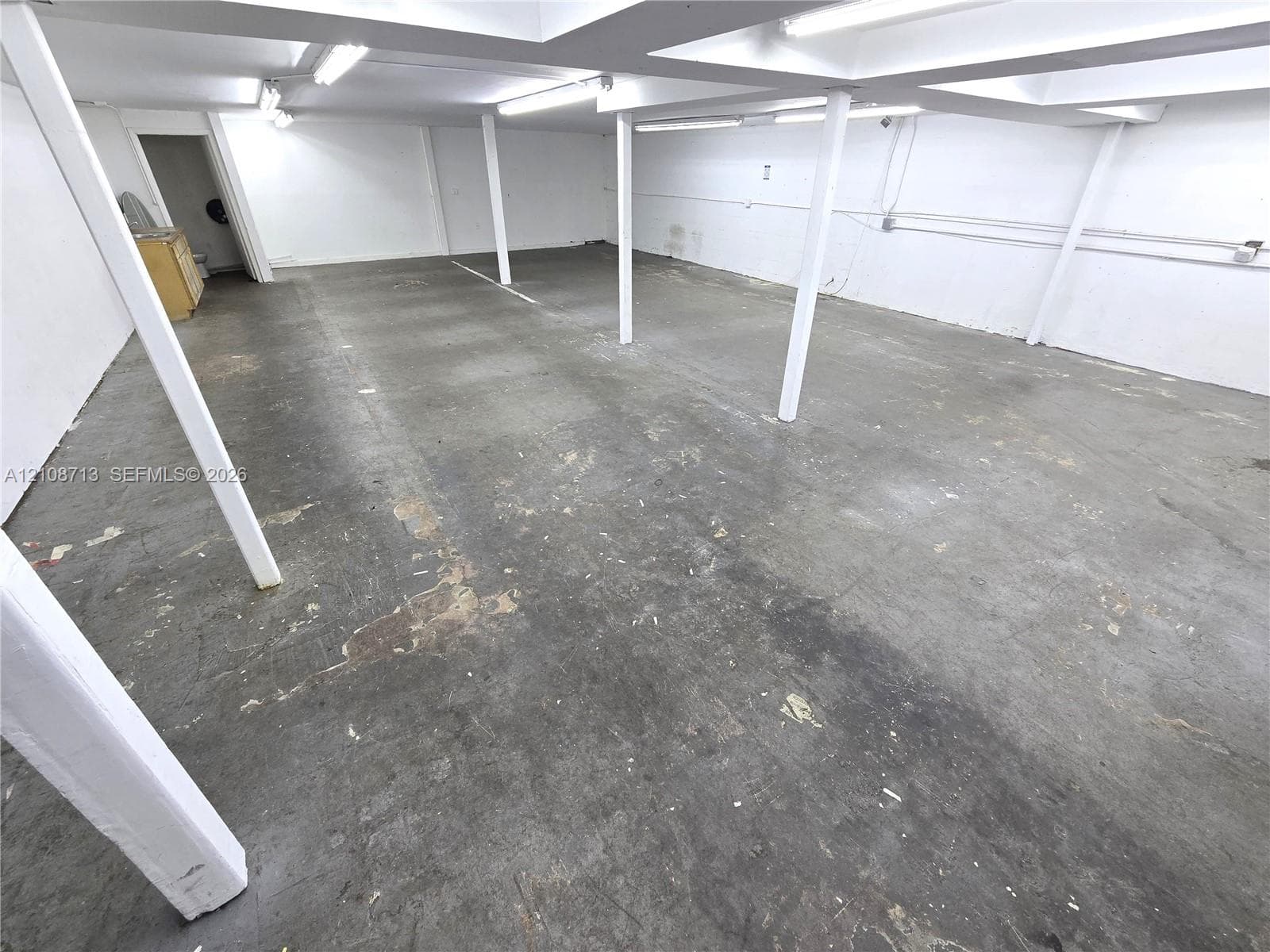 Open floor plan featuring concrete flooring, structural support columns, and recessed lighting