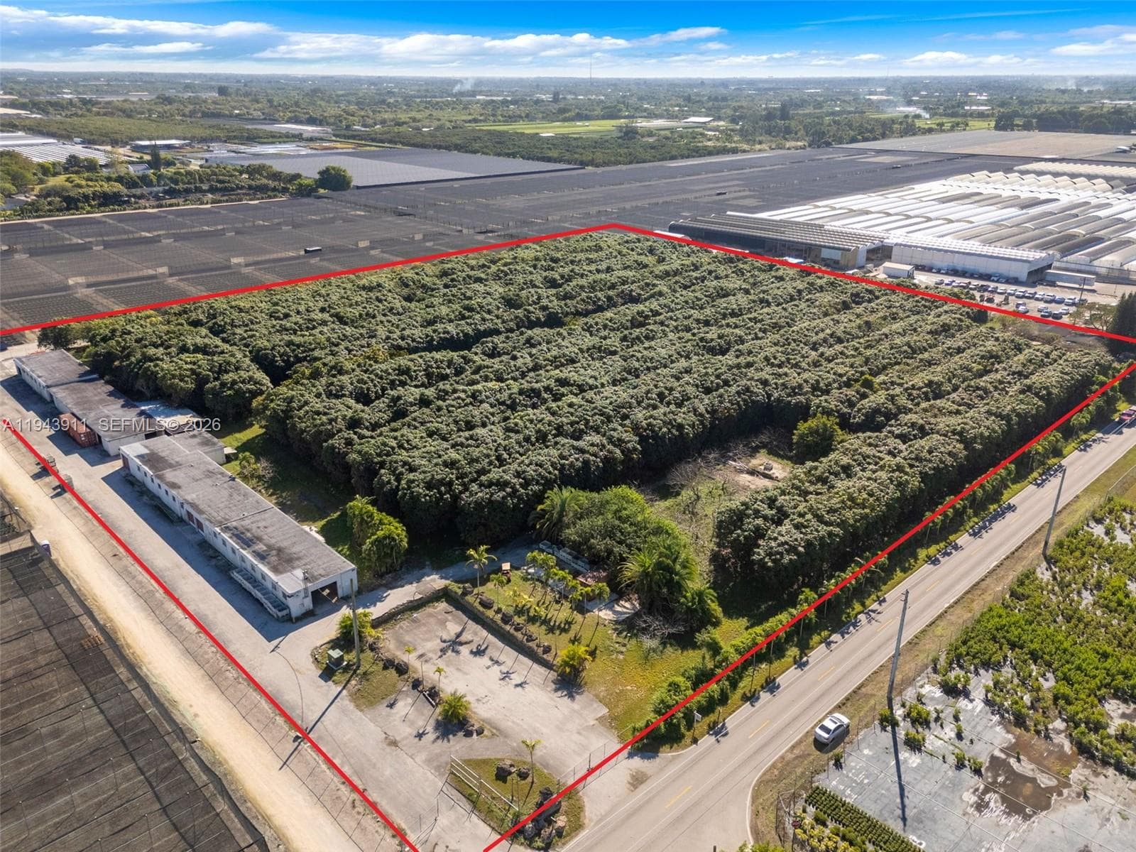 9.43 ACRE 13500 SQ FT PACKING HOUSE UP FRONT IS THE LOADING DOCK..BLDGS BEHIND 2 COOLERS THAT ARE HUGE. TOMMY AKINS MANGO GROVE FOR LEASE
