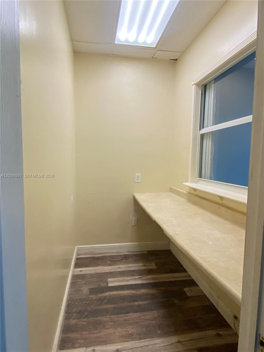 Narrow room behind reception, overlooking the large open area