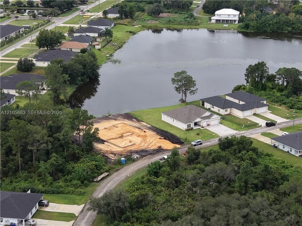 Vacant residential lot featuring direct water frontage and mature perimeter trees